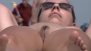 Very hot amateur voyeur smoking at the beach
